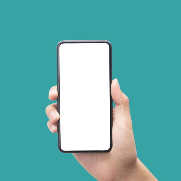 istock Man hand holding smartphone with blank screen isolated on blue background with clipping path 1339591867