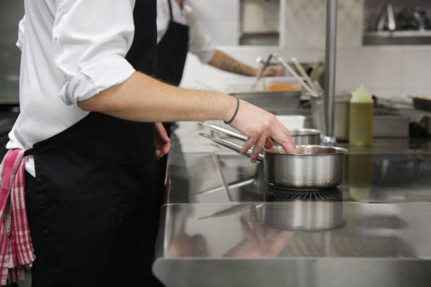 istock Busy restaurant kitchen. Chef and cooks preparing dishes. 1339594030