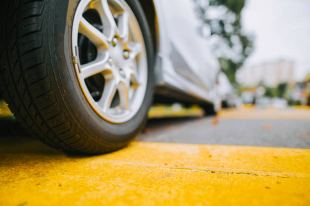 low angle Car parked next to sidewalk with yellow line