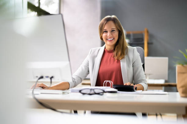 istock Accountant Women At Desk Using Calculator 1339597031