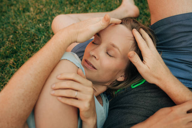 istock Man patting head of his girlfriend while resting 1339602087