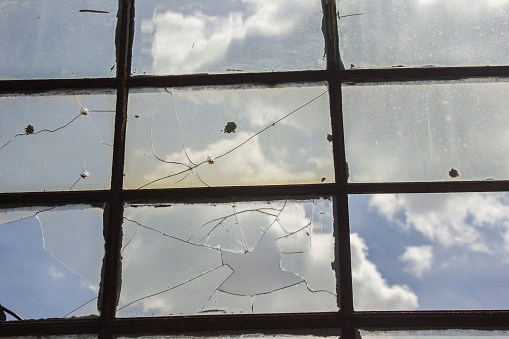 broken glass in the window. background sky, danger, devastation
