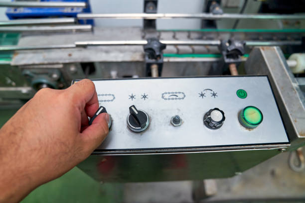 hand of worker to control switch of automatic machine in beverag - beverag imagens e fotografias de stock