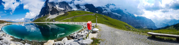 istock Panorama Eiger north face with mountain lake 1339604558
