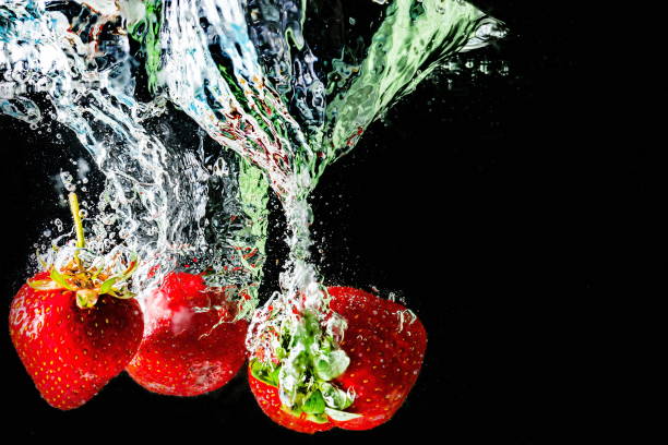 istock ripe strawberries fall into the water lifting splashes and air bubbles 1339604696