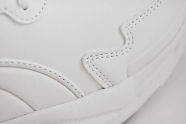istock part of white sneakers on a white background. 1339607547