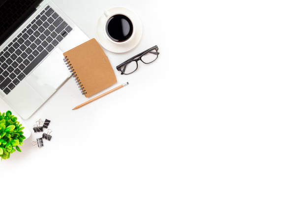 istock White office desk table with blank notebook, computer keyboard and other office supplies. Top view with copy space, flat lay. 1339613762