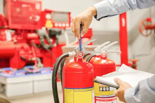 Engineer inspection Fire extinguisher and fire hose,Ready to use in the event of a fire.Safety first concept.