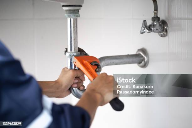 Plumber At Work In A Bathroom Plumbing Repair Service Assemble And Install Concept Stock Photo - Download Image Now