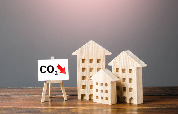 istock Green house and easel with carbon dioxide reduction. Environmentally friendly. Improving utilities and energy efficiency. Impact on environment. Reduced greenhouse gas emissions, low carbon footprint. 1339618713