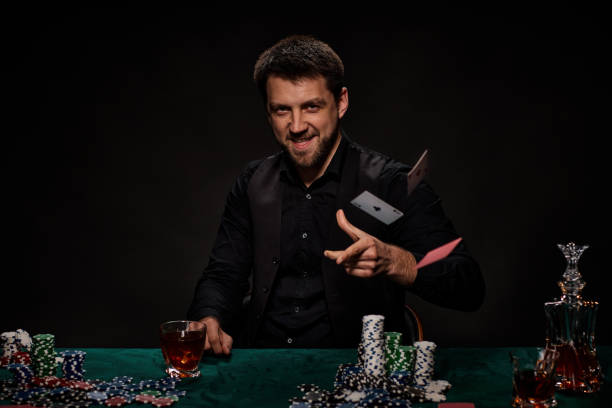 istock Bearded casino player man playing poker on green table 1339618762