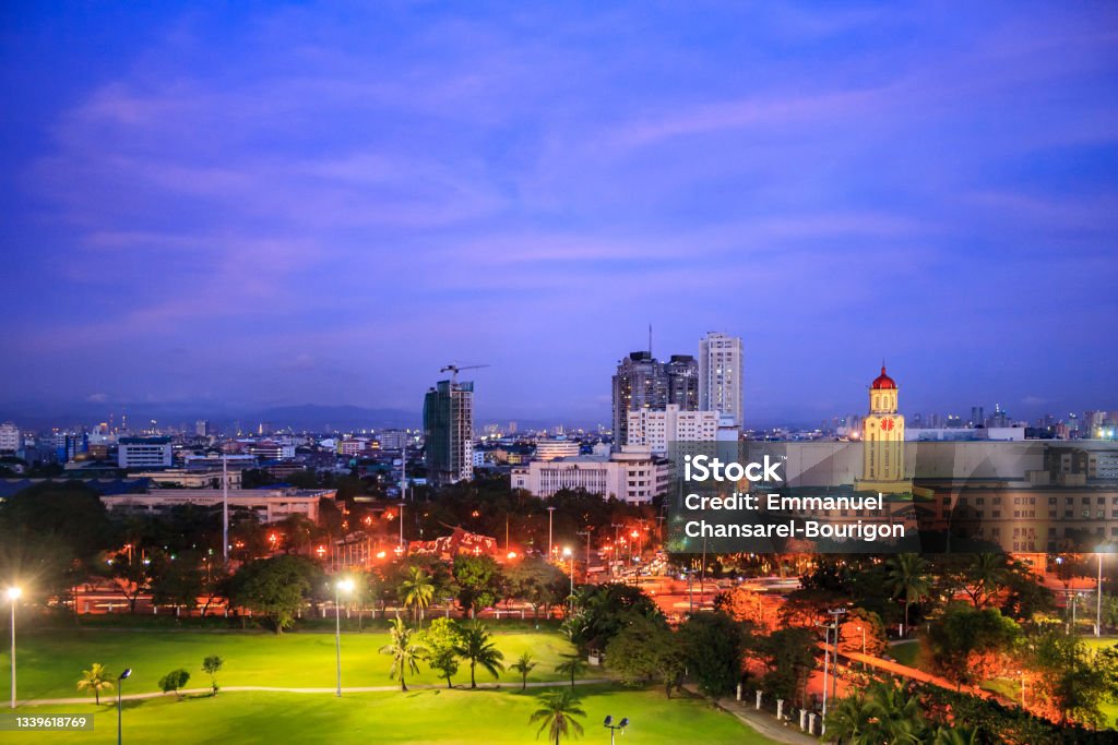 Sunset over view of Manila City Hall from Intramuros, Metro Manila, National Capital Province, Philippines. Sunset rooftop view of Manila City Hall from Intramuros, Metro Manila, National Capital Province, Philippines. Philippines Stock Photo