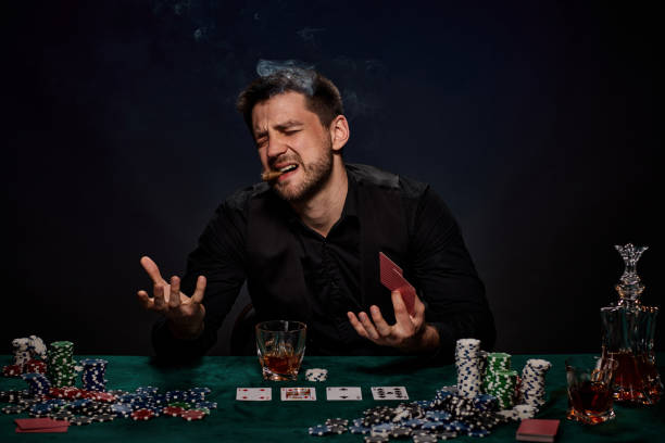 istock Bearded casino player man playing poker on green table 1339619372