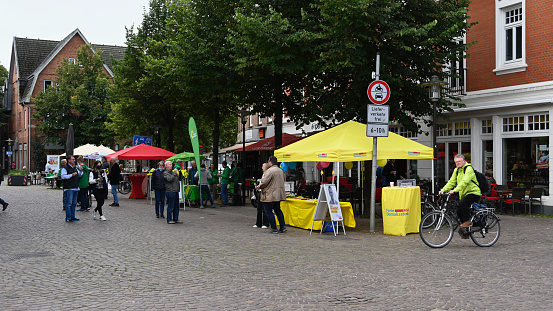 Ahrensburg, Germany, September 4, 2021 - Downtown Ahrensburg with market stalls for the federal election, some unidentified people in the background