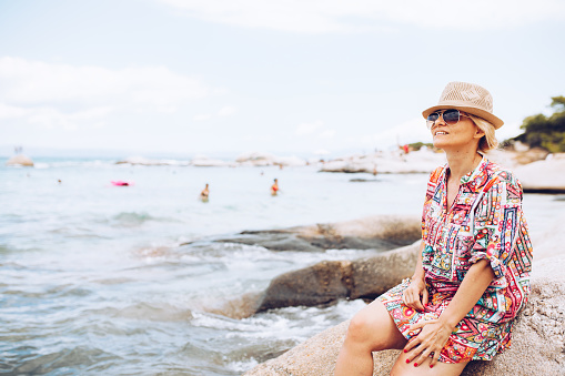 Beautiful blonde female enjoying sun and sea in Greece