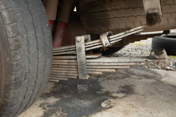 The leaf springs installed on the underside of the pickup truck are old stock photo