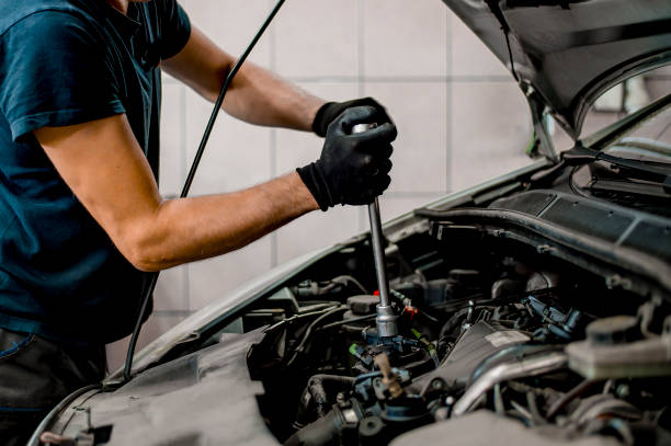 istock Auto mechanic working on car engine in mechanics garage 1339626348
