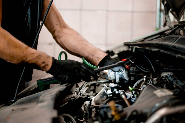 istock Auto mechanic working on car engine in mechanics garage 1339626549