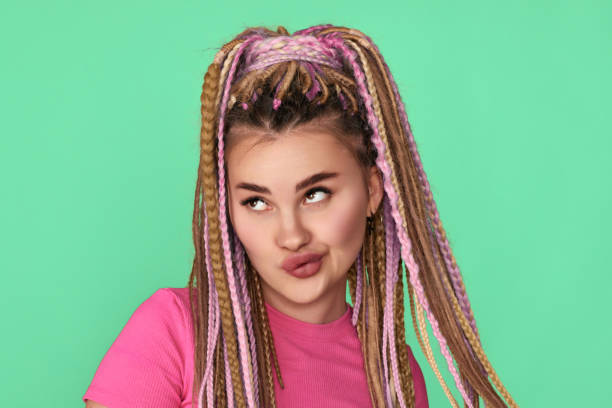 istock doubting woman with dreadlocks on blue background. 1339628323