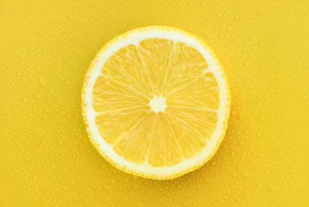istock lemon on a yellow background with drops of monochrome 1339629232