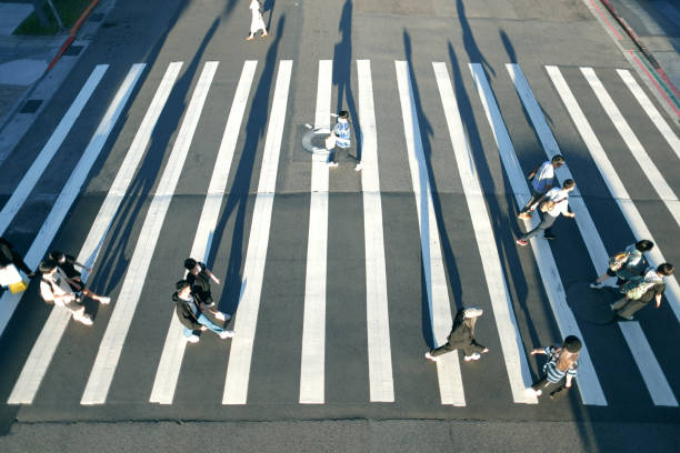 istock People wearing masks walking on zebra crossing 1339629421