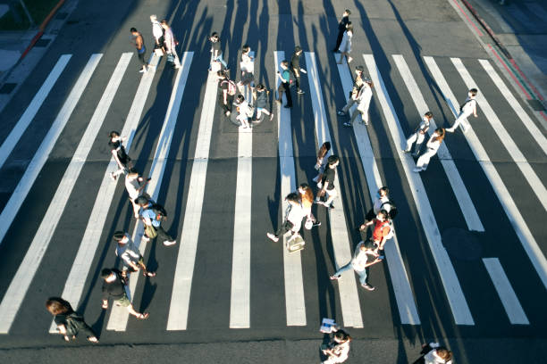 istock People wearing masks walking on zebra crossing 1339629422