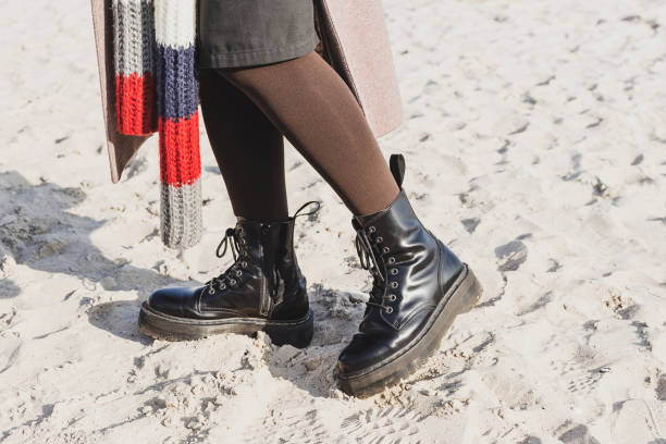 istock Stylish ankle boots in outdoor on the sand beach 1339629454