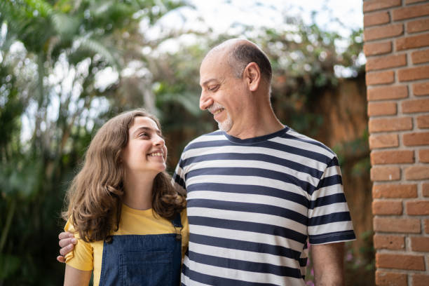 istock Father and daughter looking at each other at home 1339629647