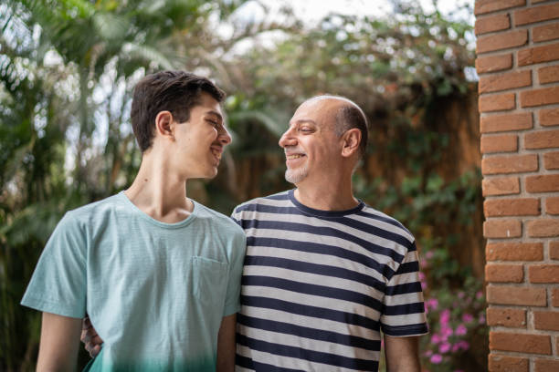 istock Father and son looking at each other at home 1339629653
