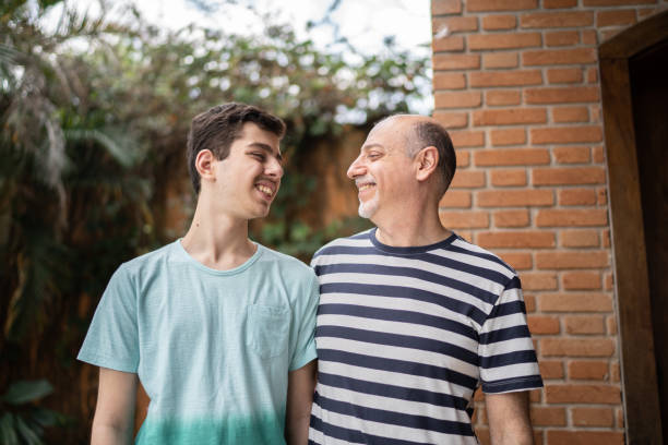 Father and son looking at each other at home Father and son looking at each other at home autism stock pictures, royalty-free photos & images