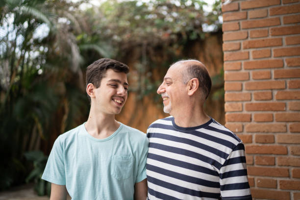 istock Father and son looking at each other at home 1339629681