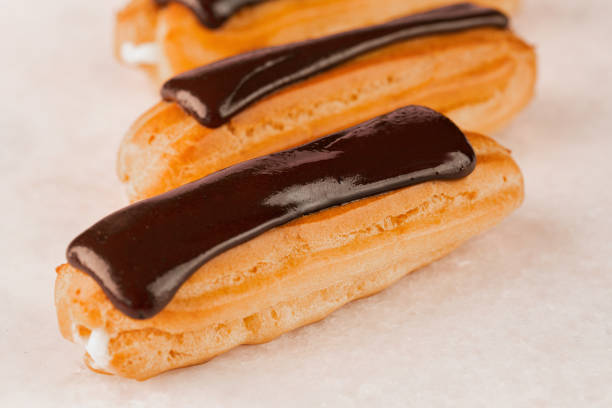 istock Eclair with chocolate cream on white background 1339633970