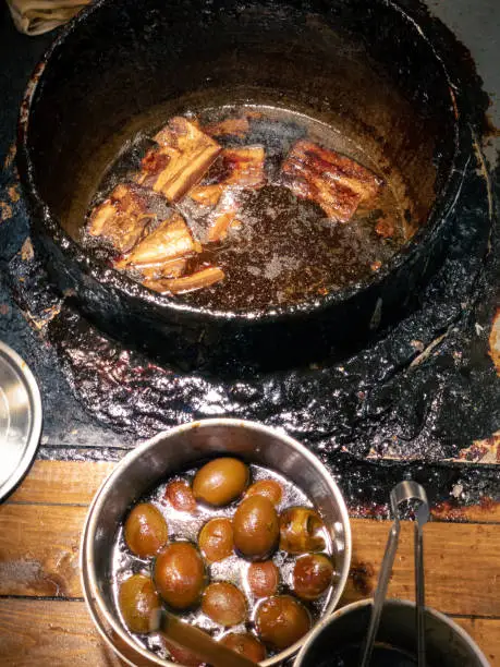 Braised pork belly on dirty braising pot. Prepare for chef cook a slice of stewed meat pig with brown sauce in chinese food style. Traditional taiwanese Dongpo. Taiwan snack street food, Asia.