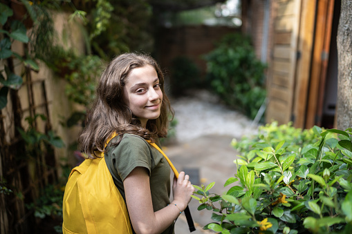 Portrait of a teenager girl with backpack at home