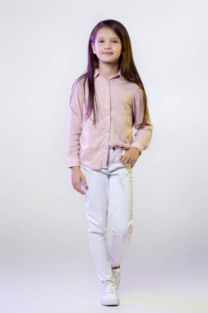 istock smiling little child girl posing on white background. 1339635265