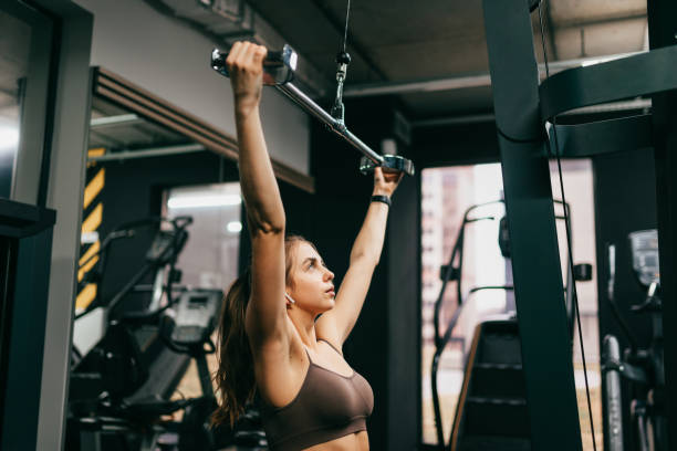 istock Beautiful woman is doing exercise in the gym 1339637339