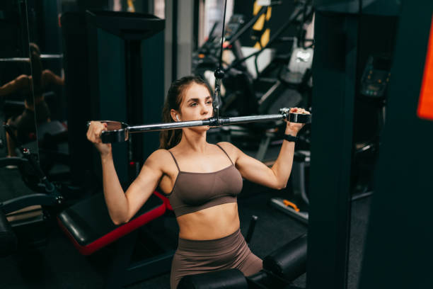 istock Beautiful woman is doing exercise in the gym 1339637340