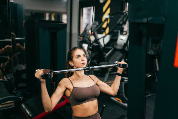 istock Beautiful woman is doing exercise in the gym 1339637341