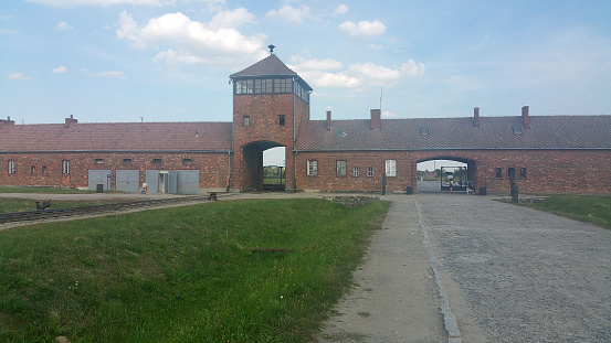 Auschwitz, Poland - August 14, 2020: Concentration and extermination camp memorial site. Auschwitz II: trains entry to the camp. Railways. Summer sunny day