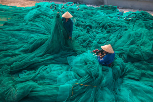 istock Two men is fixing fishing net 1339640398
