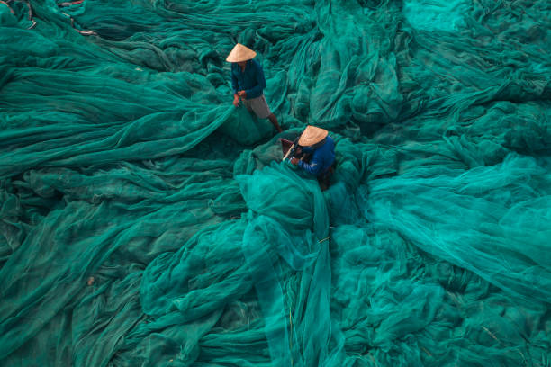 istock Two men is fixing fishing net 1339640921