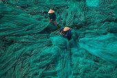 Two men is fixing fishing net