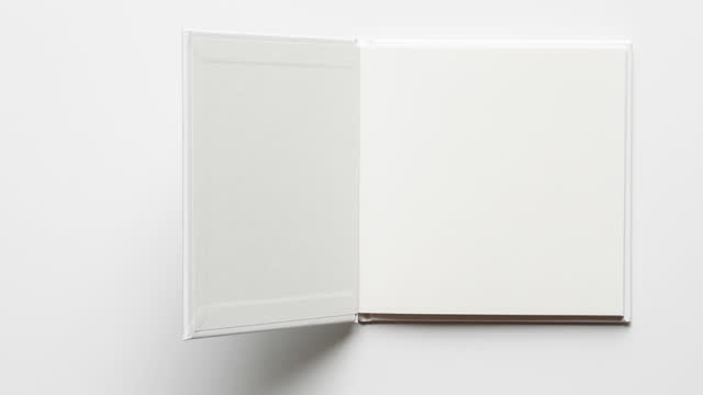 4k : Stop motion of open white notebook with blank page on wooden backgroun