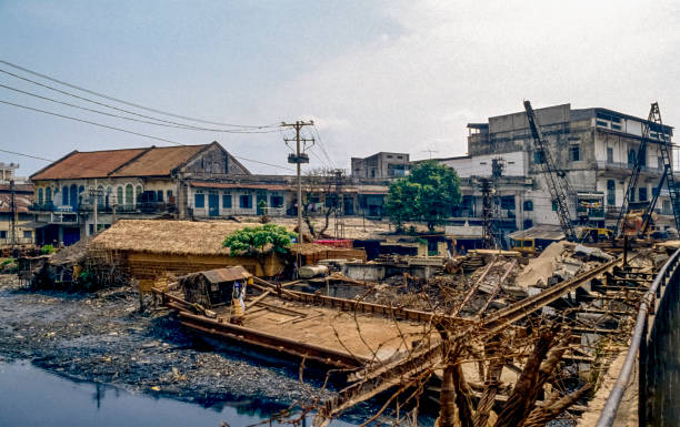Saigon View from a bridge destroyed in the Vietnam War to a row of houses on a riverbank in the Old Satd of Ho Chi Ming City in South Vietnam ho chi minh city photos stock pictures, royalty-free photos & images