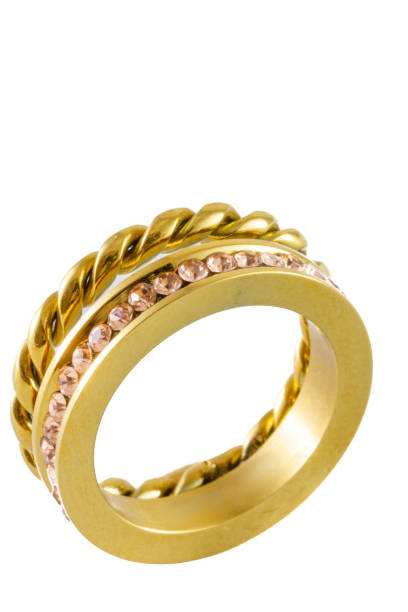 istock Knotted sparkly twin golden ring with zircons isolated on white background 1339644584