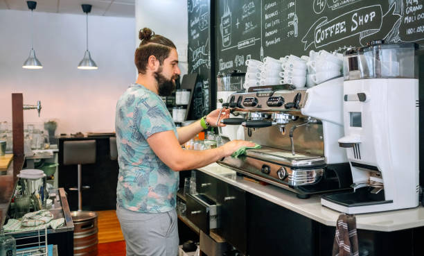 istock Young waiter cleaning the coffee machine 1339645977