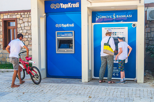 06 July 2021 Side, Turkey.  Tourist came barefoot to withdraw money from an ATM
