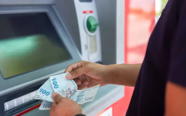 Photo of Man Counting Money İn Front Of ATM 
Cash Dispenser And Money Stock Photo