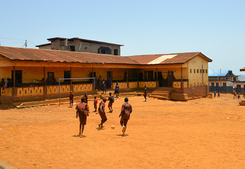 Freetown, Western Area, Sierra Leone: Congo Town school - soccer match in progress in the school playground - students in uniform - education in Sierra Leone