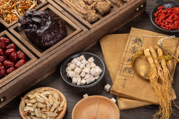 istock Ancient Chinese medicine books and herbs on the table 1339651381